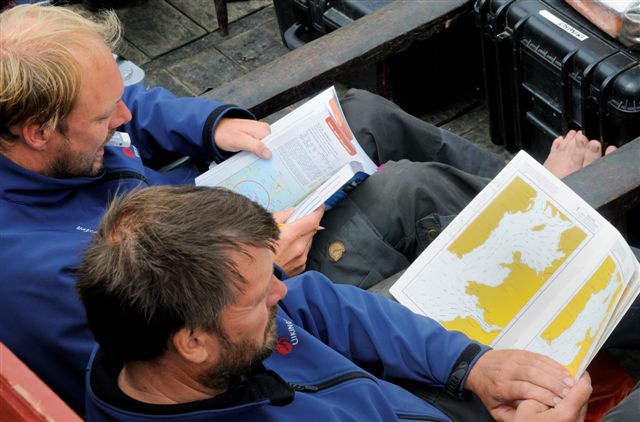 Skipper Carsten Hvid (left) and helmsman Tom Nicolaisen plan the voyage before departure to England.
