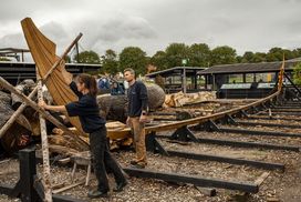 The skilful hands of boatbuilders work quickly to shape the Skuldelev 5's sternpost