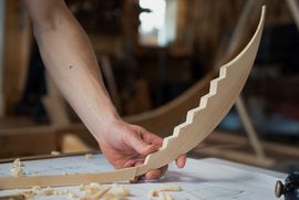 The Viking Ship Museum builds a new reconstruction of a Skuldelev ship. Handcarved miniature model of a stem for a Skuldelev ship.