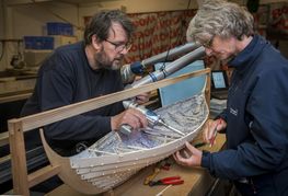 The Viking Ship Museum builds a new reconstruction of a Skuldelev ship. Ship constructor ajusting details on cardboard model of a Skuldelev ship.